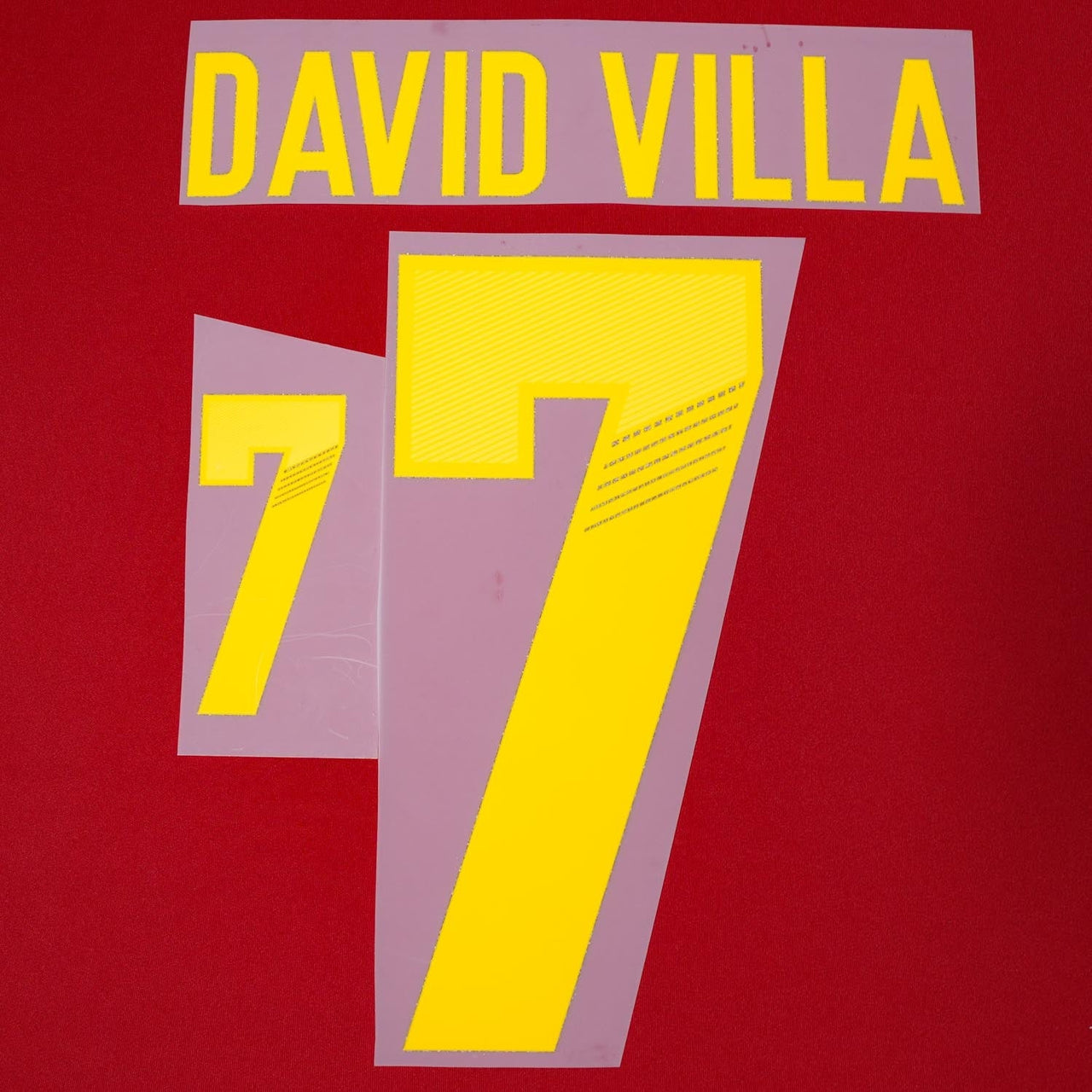 Spain football name set reproduction – red and yellow player lettering and numbering laid flat for heat-press application.